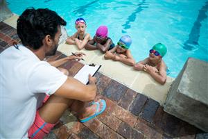 Children With Their Swim Instructor At Swim Lessons